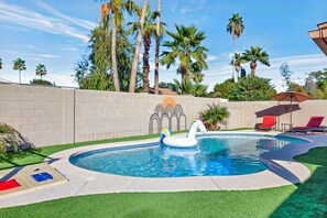 Stunning private backyard pool where you can lounge over next to palm trees