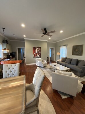 Living room with large comfy couch and 2 chairs.  Large coffee table.