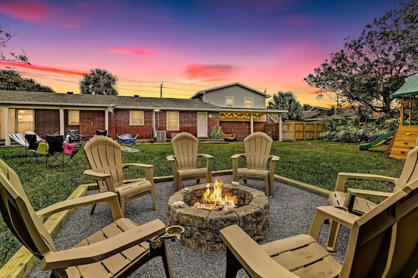 Beautiful large backyard with newly built fire pit, kids playground