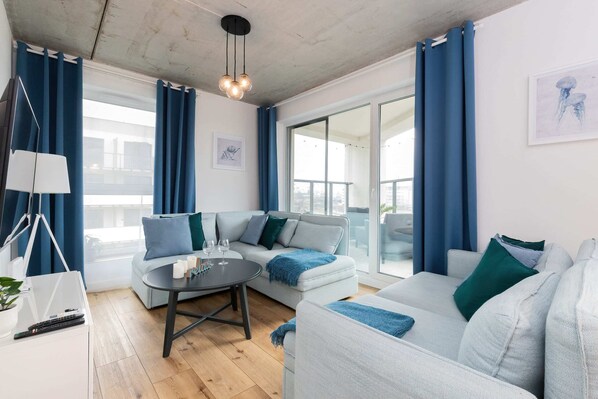 Relax in the stylish living room with comfortable sofas and modern decor.
