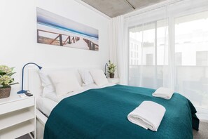 The stylish bedroom includes a comfortable double bed and a wardrobe.