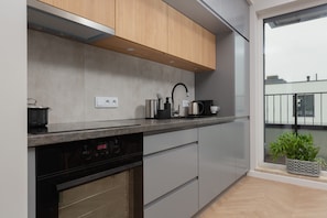 The sleek design of the kitchenette blending seamlessly with the living area.