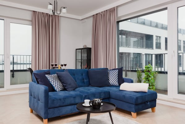 Relax in the stylish living room with a comfortable sofa and modern decor.