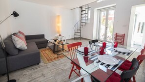 A spacious living space with an L shaped sofa and a modern dining space #airbnb #airbnblisbon #portugal #pt #lisbon #decoration #apartment #lovely #clean #modern #spacious