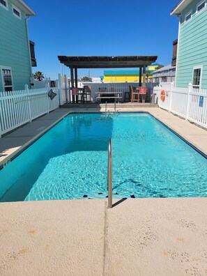 Heated community pool is steps fromt the home.