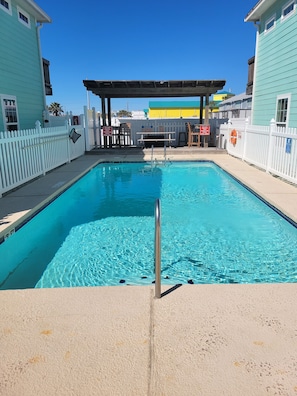Heated community pool is steps fromt the home.