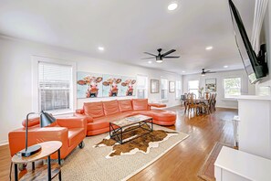 Living Room with 75" Roku TV. POV front entrance. Dining on right. 