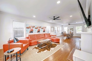 Living Room with 75" Roku TV. POV front entrance. Dining on right.