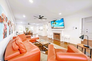 Living Room with 75" Roku TV. Front entrance on the right. Dining on left. 