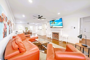 Living Room with 75" Roku TV. Front entrance on the right. Dining on left.