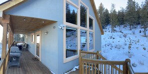 View of the house with the floor to ceiling windows that overlook the valley.