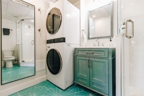 Bathroom with full size washer/dryer and mirror and provided detergent