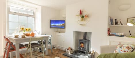 Cosy lounge and dining area centres around the welcoming log burner. 