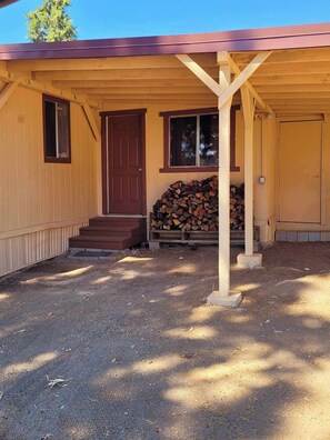 Carport with wood rack for wood burning stove
