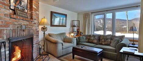 Our cozy one bedroom condo features a homey living area with wood burning fireplace.