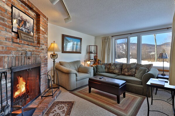 Our cozy one bedroom condo features a homey living area with wood burning fireplace.