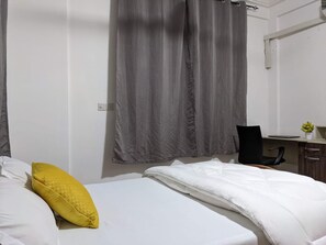 Bedroom with double bed, work desk and TV