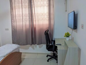 Work desk and chair and TV in bedroom