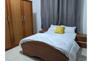 Double bed, bedside tables, and wardrobe