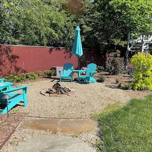Firepit with supplied wood and roasting sticks.