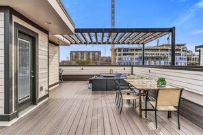 Spend time on the spacious rooftop patio with dining table and chairs, patio seating and gas fire pit.