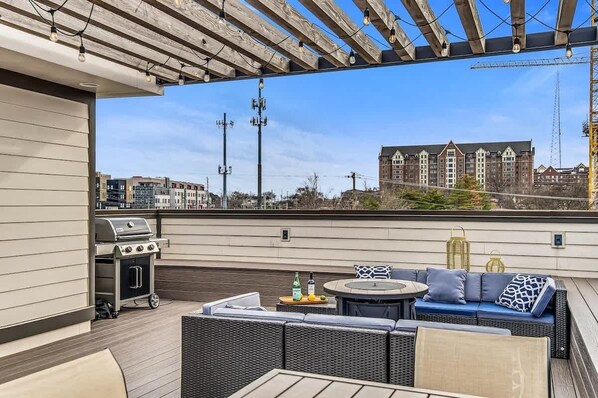 Spend time on the spacious rooftop patio with dining table and chairs, patio seating and gas fire pit.