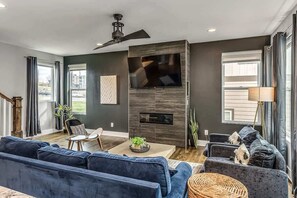 Living Room: Spacious layout with striking decor and natural light for relaxation and fun!