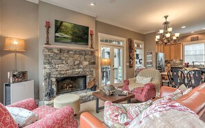 Cozy living room with stone fireplace and plush seating.