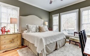 Elegant bedroom with king-size bed and natural light.