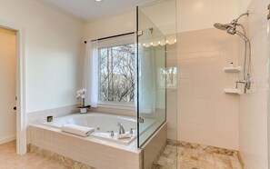The Jetted Tub and Glass Walk-in Shower in the Master Bedroom