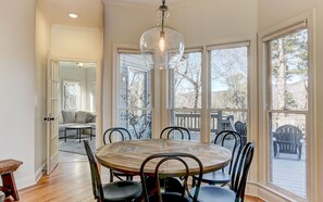 Dinning Room Table Infront of Large Open Windows to Enjoy the View