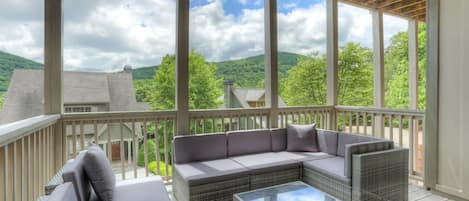 Elegant deck lounging with serene mountain vistas - relax in style.