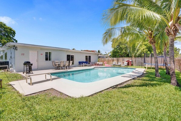 Enjoy the resort style yard surrounded by lush palms