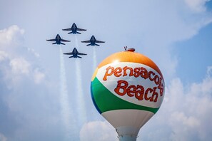 The Navy’s Blue Angels flying in diamond formation over the Pensacola Beach water tower. Practice schedules can be found online and viewed by the public from multiple locations.