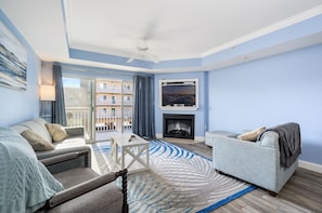 There is plenty of seating to relax and watch a movie or play a boardgame together in this lovely living room. *Fireplace is decorative only*