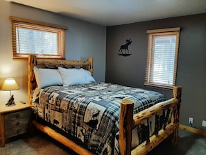Master bedroom queen size bed with TV.