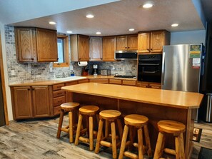Kitchen with all the appliances and dishes  you need to make any meal.