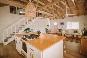 Large kitchen island featuring GE Café gas range.