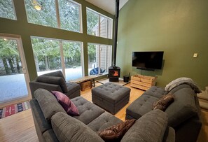 Enjoy a cozy fire and the forest from the comfy and configurable couch.