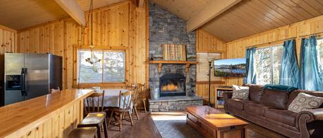 LIVING ROOM AREA WITH WOOD BURNING FIREPLACE, SMART T.V AND BLUERAY/DVD. ACCESS TO DECK