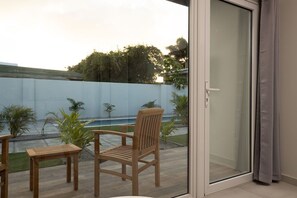 Enjoy the view of the garden and pool while relaxing outdoor.
