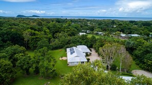 View of house with sea and Double Island in background 