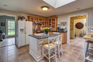 Enjoy the fully stocked kitchen with middle island, perfect for entertaining. 