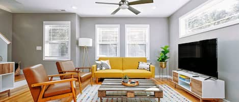 Living room. The yello couch has been replaced with a brand new brown leather co