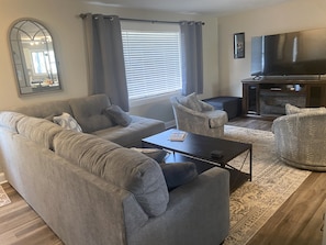 Great room with electric fireplace and 65 inch HD TV