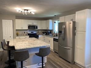 Kitchen with huge island with seating for 4.