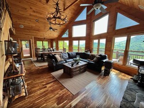 Living room with comfortable upscale furnishings and spectacular mountain views.