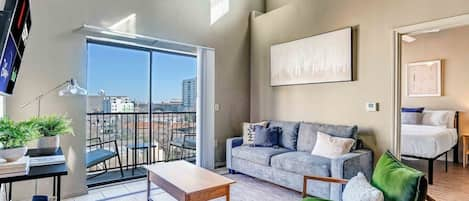 Living room with smart TV and small balcony