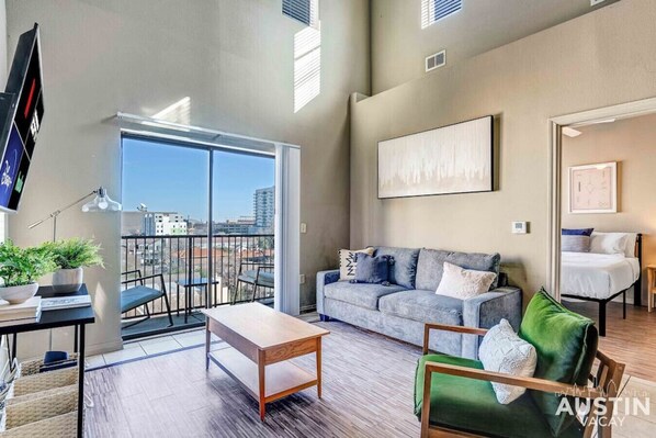 Living room with smart TV and small balcony