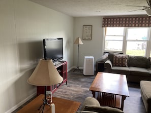 New furniture in the large living room with pullout queen sofa bed.